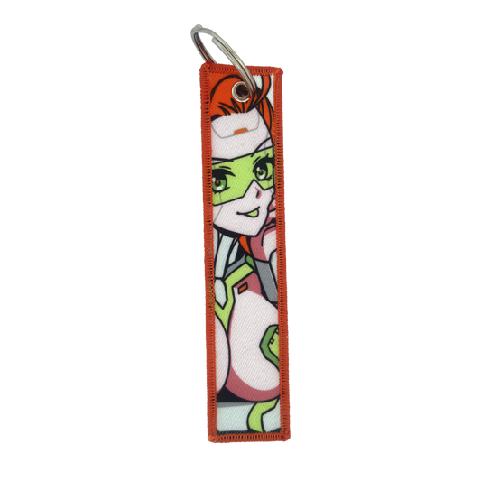 Keychain with a repeating design of a red-haired woman in a white and green futuristic suit with green glasses.