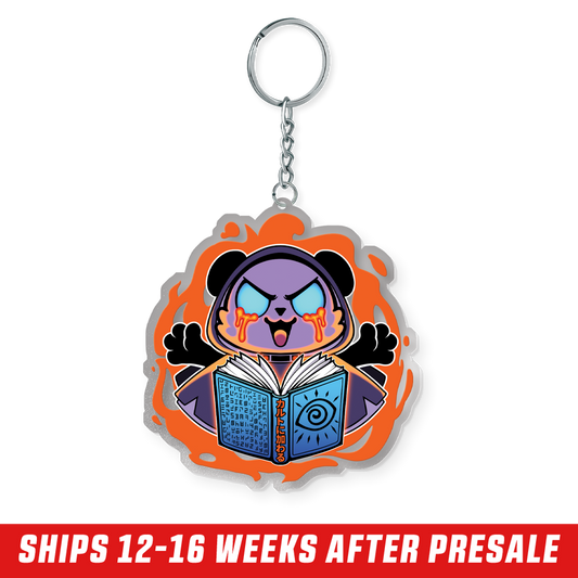 Purple cartoon bear with glowing blue eyes and orange tears holding a blue book surrounded by an orange flame design keychain