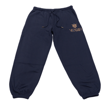 Navy sweatpants with gold embroidered VCard logo and gold-tipped drawstring on soft fabric.